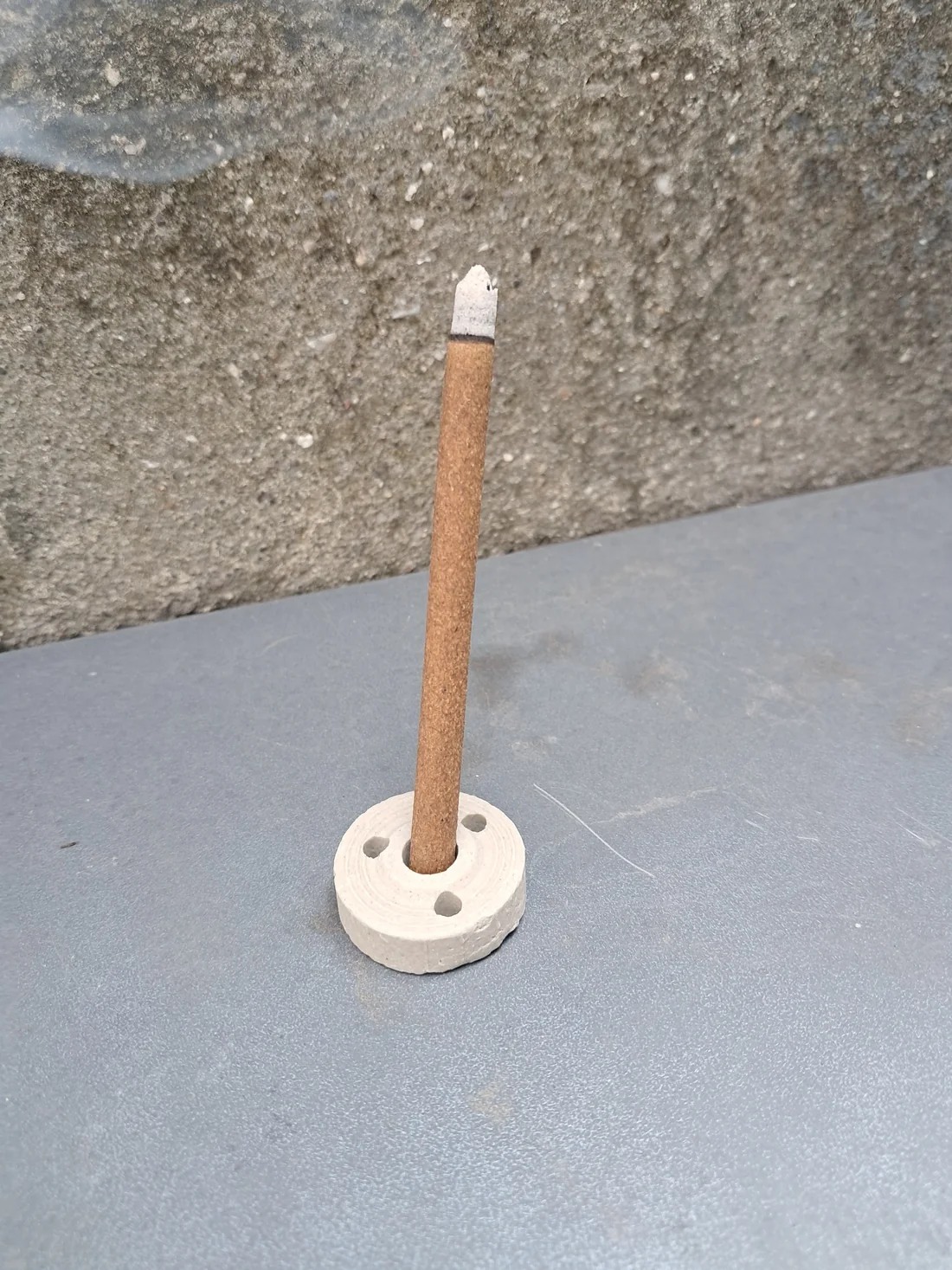 Our actual coreless brown dhoop stick in its circular holder